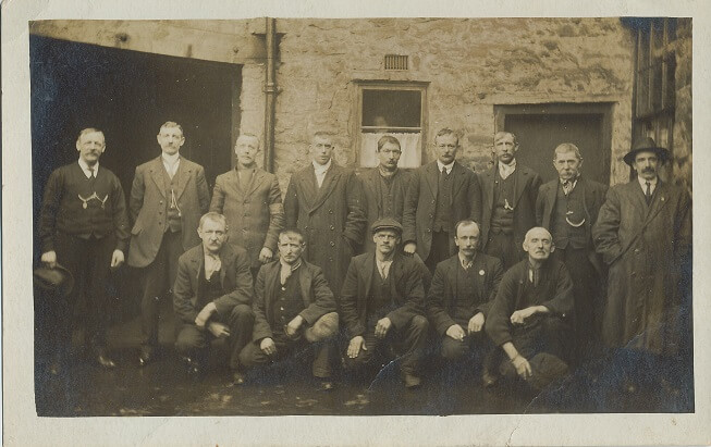 Black and white photo of a group of men from Bolton