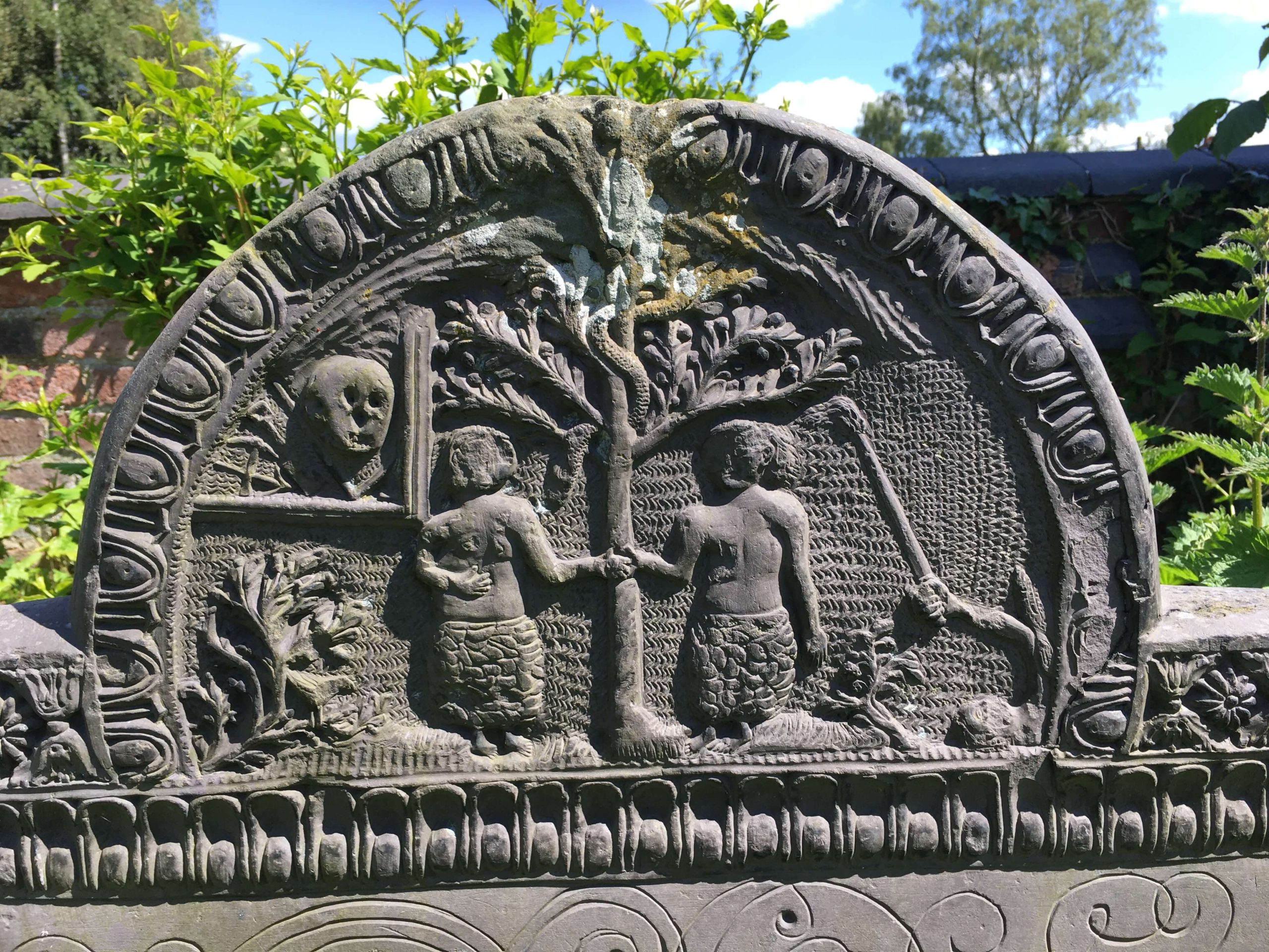 Close up of adam & eve on swithland slate headstone. Church Langton